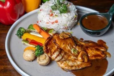 a plate of food with rice and meat and vegetables at Citadines Sukhumvit 11 Bangkok in Bangkok