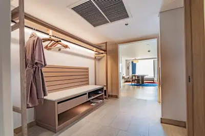a dressing room with a bench and a mirror at Montien Hotel Surawong Bangkok in Bangkok