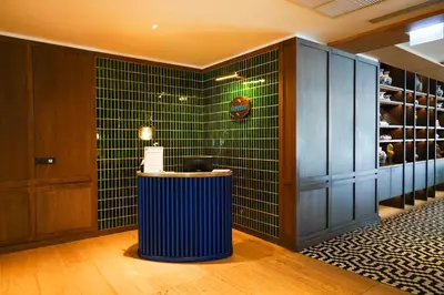 a tasting room with green tiled walls and a counter at Montien Hotel Surawong Bangkok in Bangkok