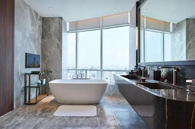a bathroom with a tub and a large window at Centara Grand At CentralWorld in Bangkok