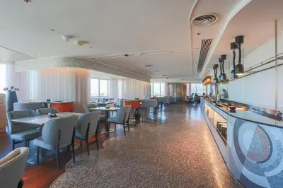 a restaurant with tables and chairs in a room at Centara Grand At CentralWorld in Bangkok