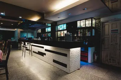 a bar with a counter and chairs in a restaurant at Convenient Park Bangkok in Bangkok