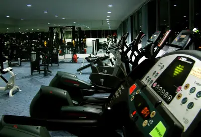 a row of motorcycles parked in a gym at Convenient Park Bangkok in Bangkok