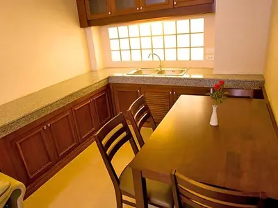 a kitchen with a table with chairs and a sink at Convenient Park Bangkok in Bangkok