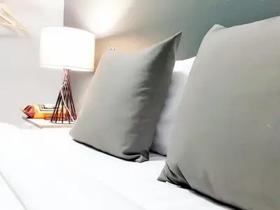 a bed with two pillows and a lamp on it at Baan Pinklao in Bangkok