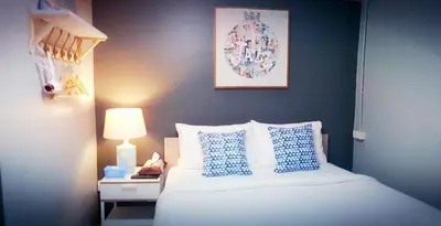 a bedroom with a white bed with blue pillows at Baan Pinklao in Bangkok
