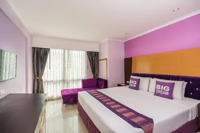 a bedroom with a large bed with purple walls at Citin Pratunam Bangkok by Compass Hospitality in Bangkok