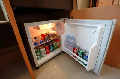 an open refrigerator filled with lots of food and drinks at Citin Pratunam Bangkok by Compass Hospitality in Bangkok