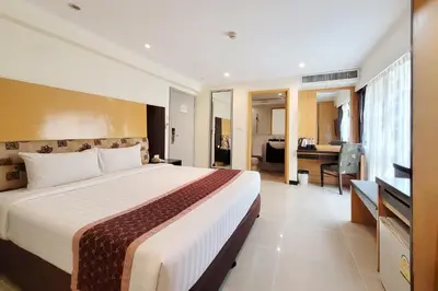 a hotel room with a large bed and a desk at Citin Pratunam Bangkok by Compass Hospitality in Bangkok