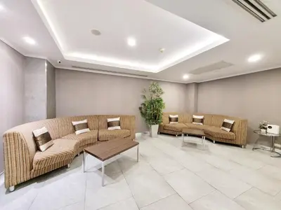 a hospital waiting room with couches and tables at Citin Pratunam Bangkok by Compass Hospitality in Bangkok