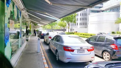 a group of cars parked next to a parking lot at Popular Condo by Jintana in Pak Kret