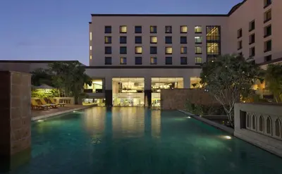 a large swimming pool in front of a building at Dusit Princess Srinakarin Bangkok in Bangkok