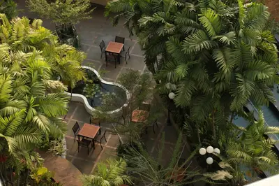 an overhead view of a pool with chairs and trees at Dusit Princess Srinakarin Bangkok in Bangkok