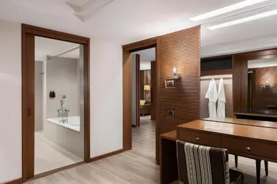 a bathroom with a vanity and a sink and a tub at Dusit Princess Srinakarin Bangkok in Bangkok