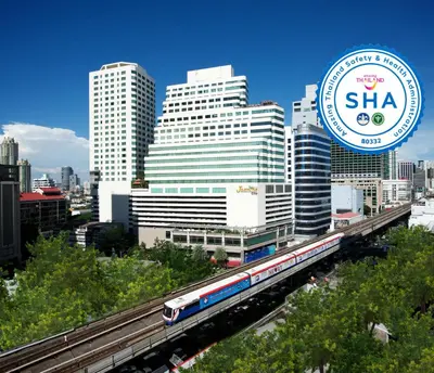 a train on the tracks in front of a city at Jasmine City Hotel in Bangkok