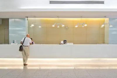 a man standing at a counter in a store at Baiyoke Suite Hotel in Bangkok