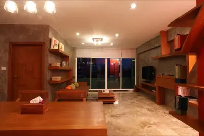 a living room with a table and a couch at Baannueng at Aree 5 Hotel in Bangkok