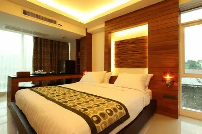 a bedroom with a large bed with a wooden wall at Baannueng at Aree 5 Hotel in Bangkok