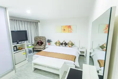 a hotel room with a bed and a tv at Pratunam City Inn in Bangkok