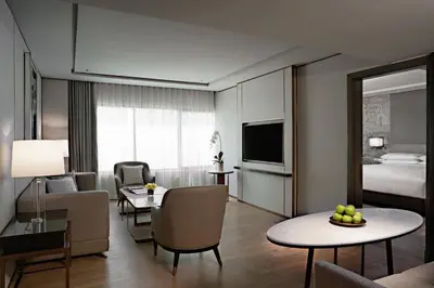 a hotel room with a living room with a bed and a living room at JW Marriott Hotel Bangkok in Bangkok