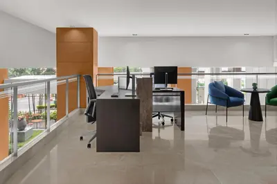 an office with a desk and chairs on a balcony at Courtyard by Marriott Bangkok in Bangkok