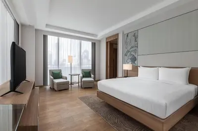 a bedroom with a bed and a flat screen tv at Courtyard by Marriott Bangkok in Bangkok