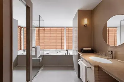 a bathroom with a tub and a sink and a mirror at Courtyard by Marriott Bangkok in Bangkok