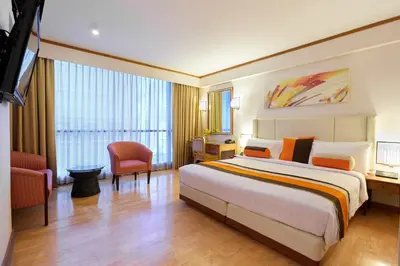 a hotel room with a large bed and a television at The Four Wings Hotel Bangkok in Bangkok