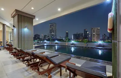 a pool on the roof of a building with a city skyline at The Four Wings Hotel Bangkok in Bangkok