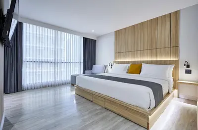a bedroom with a large bed and a large window at The Four Wings Hotel Bangkok in Bangkok