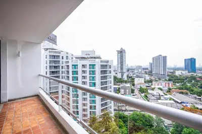 a balcony with a view of a city at Chatrium Sathon Bangkok in Bangkok
