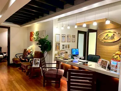 a office with a desk with a computer and chairs at The Quarter Saladaeng by UHG in Bangkok