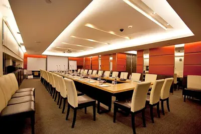 a long dining room with a long table and chairs at The Quarter Saladaeng by UHG in Bangkok
