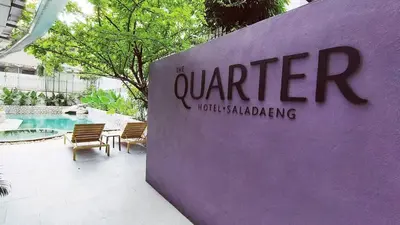 a purple sign for a quartier your advancing sign at The Quarter Saladaeng by UHG in Bangkok