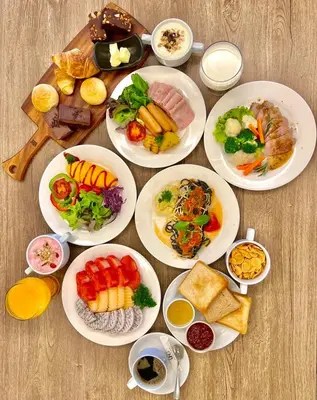 a group of plates of food on a table at The Quarter Saladaeng by UHG in Bangkok