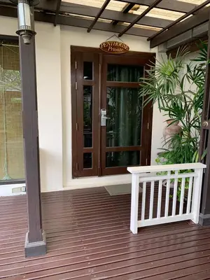 a house with a wooden door and a porch at The Siam Heritage Hotel in Bangkok