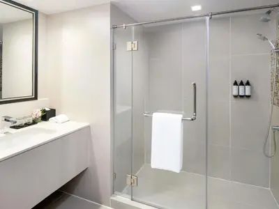 a bathroom with a shower and a sink at Mercure Bangkok Sukhumvit 11 in Bangkok