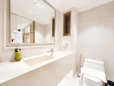 a white bathroom with a sink and a mirror at Citrus Sukhumvit 13 Nana Bangkok by Compass Hospitality - Newly Renovated in Bangkok