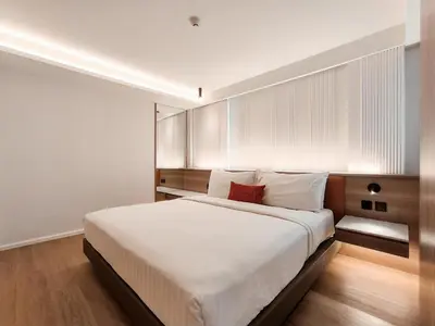 a bedroom with a large bed with white sheets at Citrus Sukhumvit 13 Nana Bangkok by Compass Hospitality - Newly Renovated in Bangkok