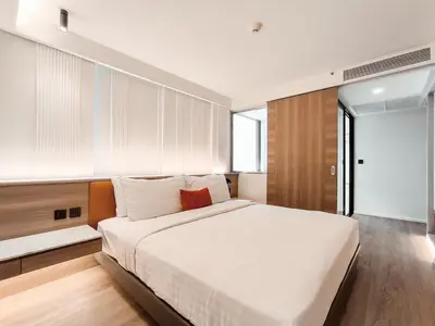a bedroom with a large white bed and a window at Citrus Sukhumvit 13 Nana Bangkok by Compass Hospitality - Newly Renovated in Bangkok
