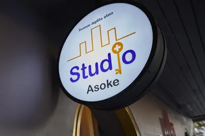 a sign for a blind assistive sign in a store at Studio Asoke in Bangkok