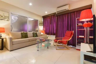 a living room with a couch and a chair at iCheck inn Residence soi 2 in Bangkok