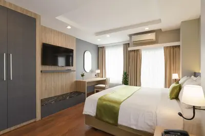 a hotel room with a bed and a television at iCheck inn Residence soi 2 in Bangkok
