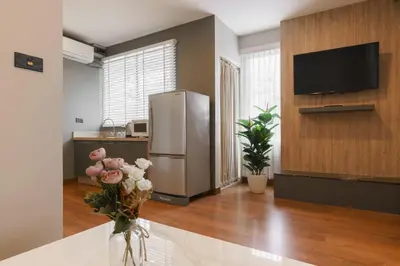 a kitchen with a stainless steel refrigerator and a tv at iCheck inn Residence soi 2 in Bangkok