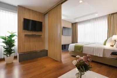 a hotel room with a bed and a flat screen tv at iCheck inn Residence soi 2 in Bangkok