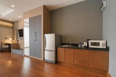 a kitchen with a refrigerator and a microwave at iCheck inn Residence soi 2 in Bangkok