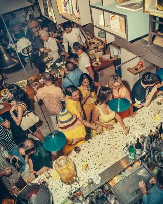 a group of people sitting around a table in a room at Sacha's Hotel Uno in Bangkok
