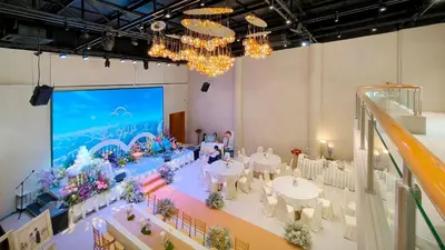 a large room with tables and chairs and a screen at Metro Point Bangkok in Bangkok