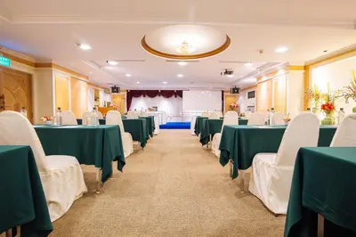 a banquet hall with green tables and white chairs at Metro Point Bangkok in Bangkok