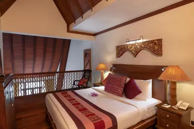 a bedroom with a large bed with a phone on it at Ariyasom Villa in Bangkok